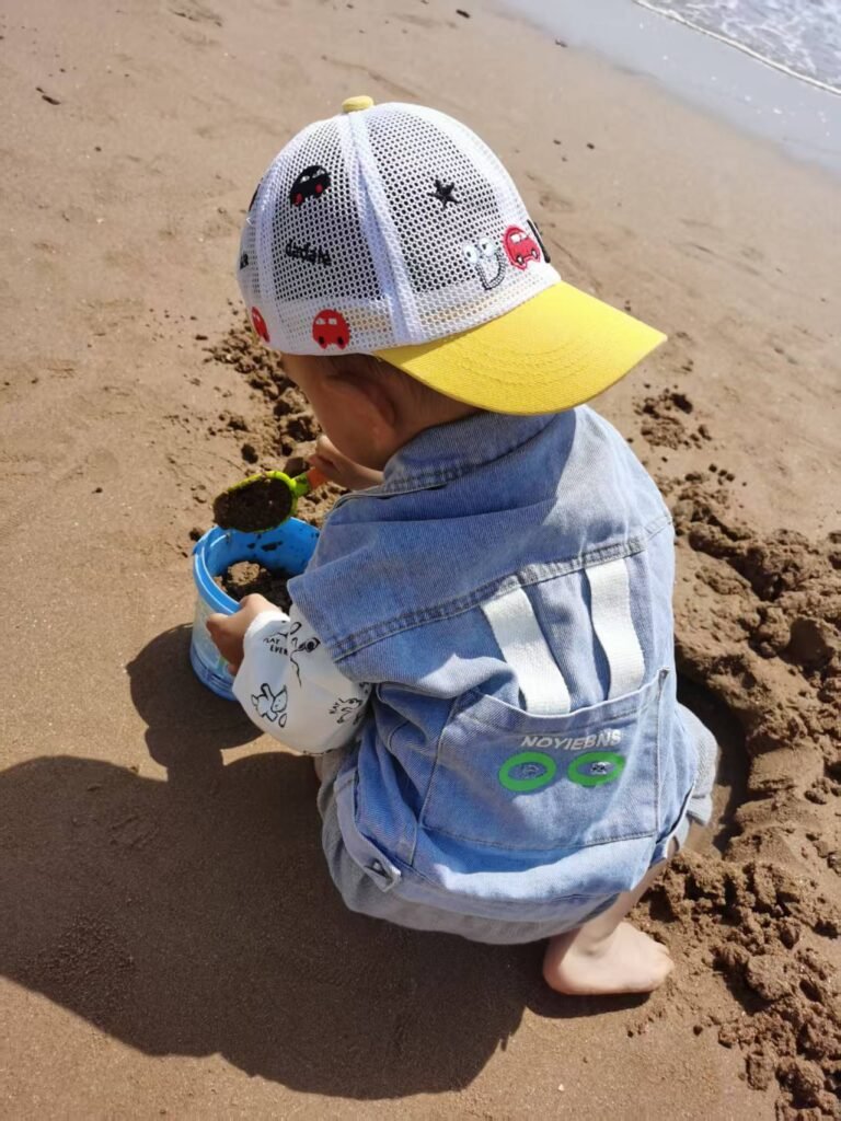TuBao playing with sand by the sea after testicular yolk sac tumor surgery